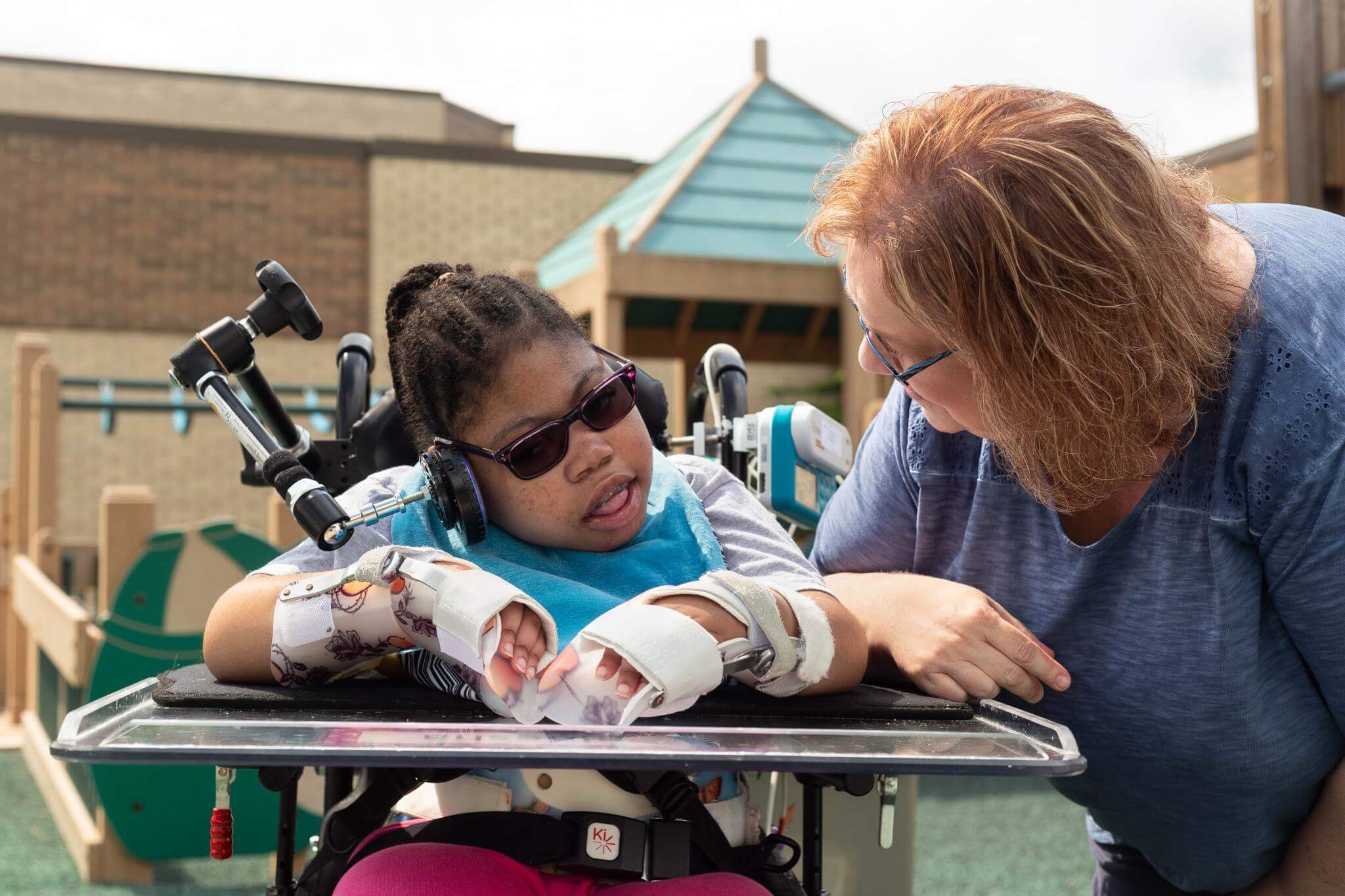 Caregiver talking to child outside